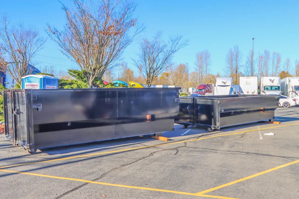 Professional dumpster rental service with roll-off container on residential driveway in Alden